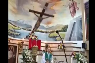 priest falling crucifix